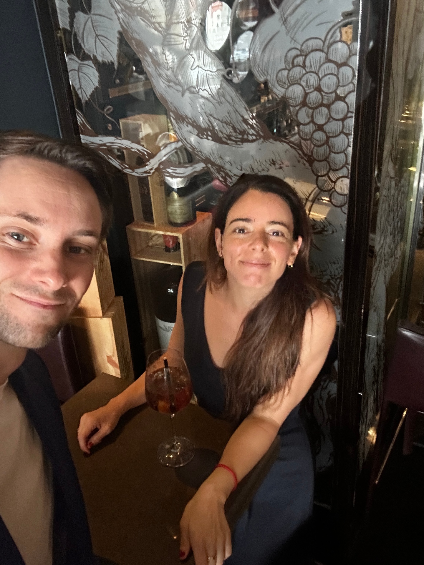 Friends sharing a Soria Spritz at the bar
